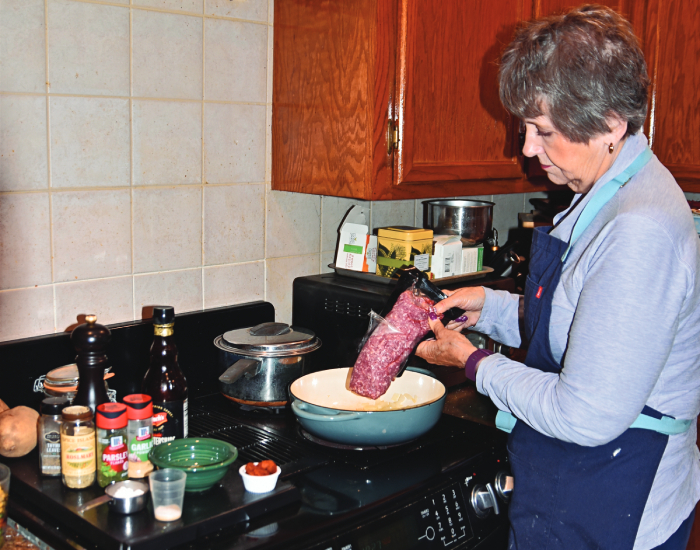 Elaine prepares lamb burgers.